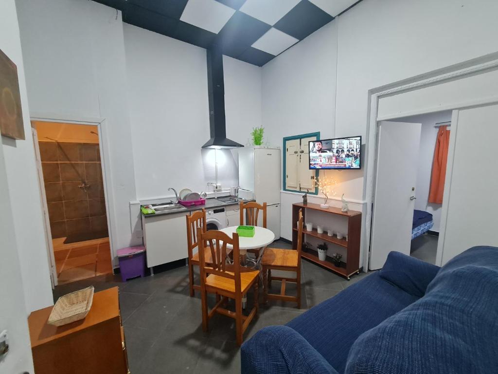 a living room with a blue couch and a table at Casa OASIS in Almonte