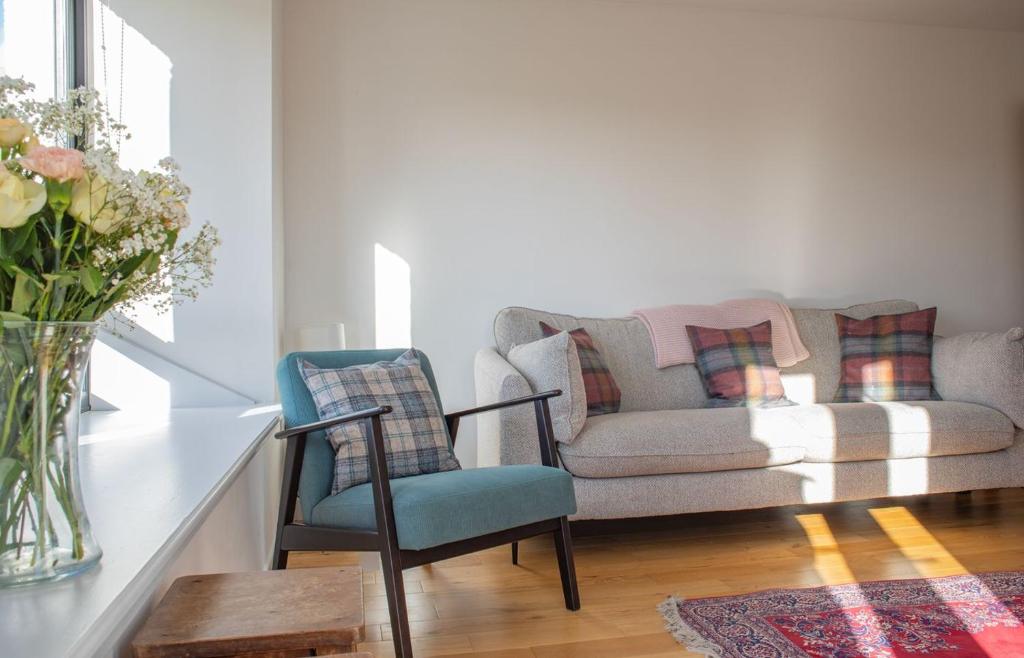 a living room with a couch and a chair at 3 Carbost in Tole