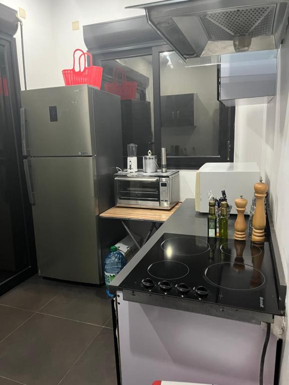 a kitchen with a stove and a refrigerator at Therese Home in Ngor