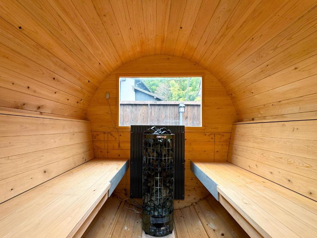 a sauna with two benches and a window in it at SAUNA HOUSE Yutagawa in Tsuruoka