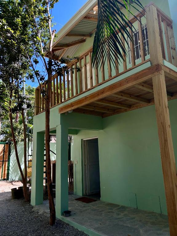 a house with a wooden deck on top of it at Oasis Cabarete Guesthouse in San Felipe de Puerto Plata