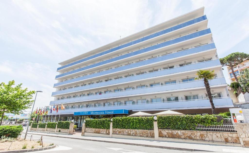 a large white building with blue windows at BLUESEA Montevista Hawai in Lloret de Mar