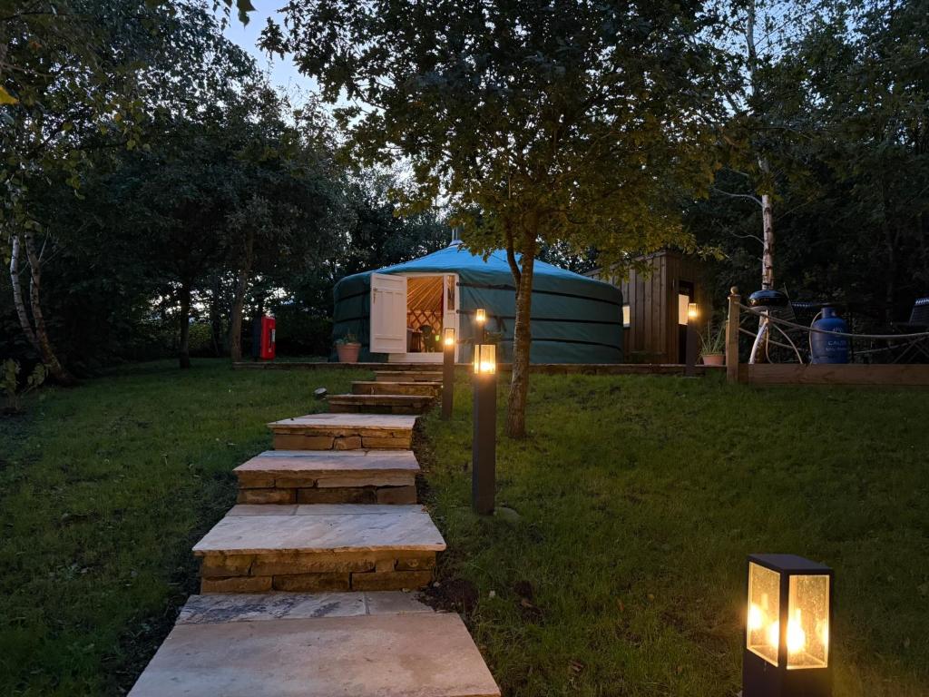 a row of steps leading up to a yurt with lights at Yurt with Hot Tub near Hartington, Peak District in Buxton