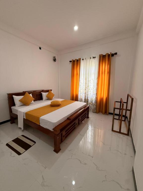 a bedroom with a large bed in a room at Chara Bloom Hotel in Dickwella