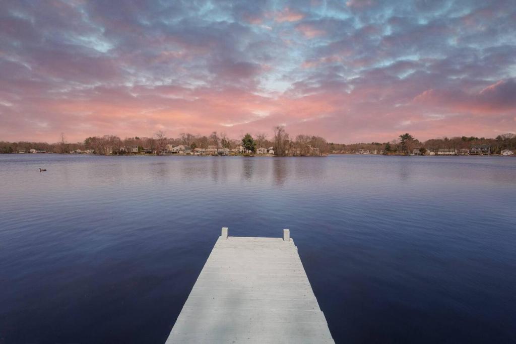 a dock in the middle of a large body of water at Hidden Gem Lake House 3BR, 2.5BA in Holbrook
