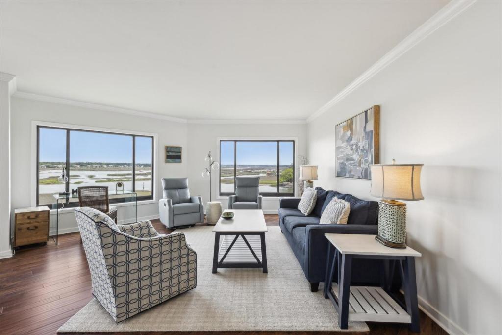 a living room with a blue couch and chairs at 261 Captains Quarters in Hilton Head Island