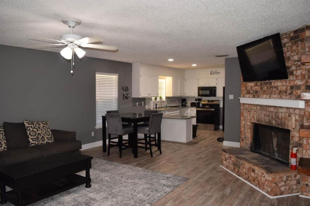 a living room with a couch and a fireplace at The Duplex in Lubbock
