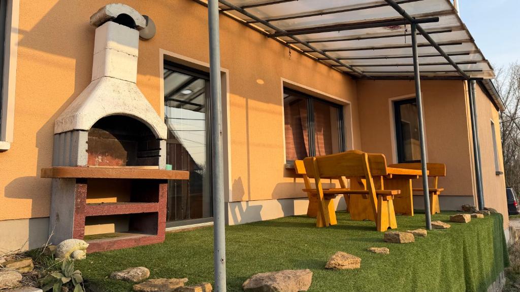 a patio with a pizza oven and a table and chair at Ferienwohnung Freund & Berndt in Nermsdorf