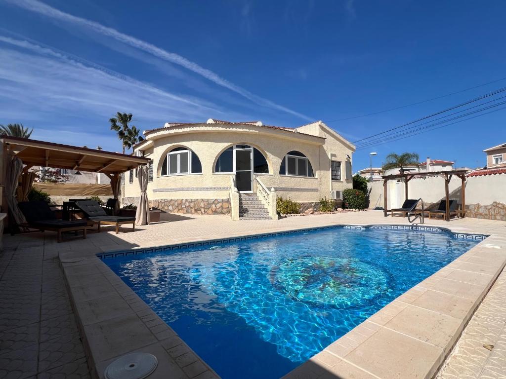 a house with a swimming pool in front of a house at Casa Noel in Ciudad Quesada