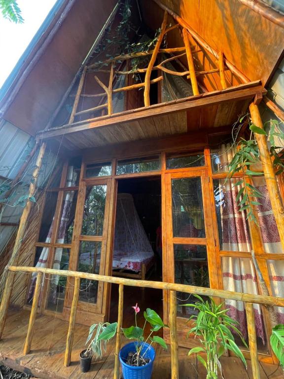 a house with windows and plants in front of it at Ella Rock Lodge in Ella