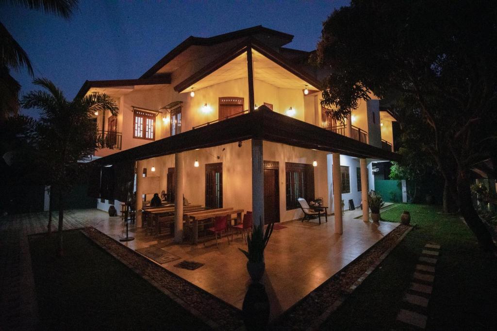 a large house at night with a patio at Yala Lemon View in Tissamaharama