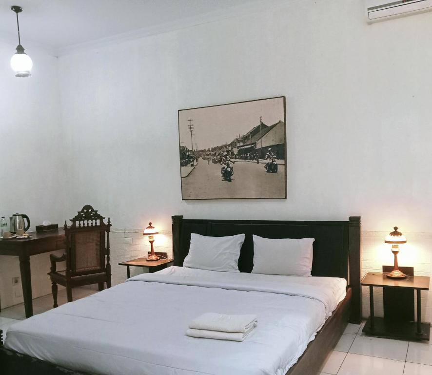 a bedroom with a bed with two towels on it at Palagan Boutique Hotel in Ngaglik
