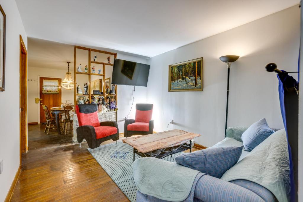 a living room with a blue couch and a table at Pool Table & Shared Sauna! Potomac River Basecamp in Westernport