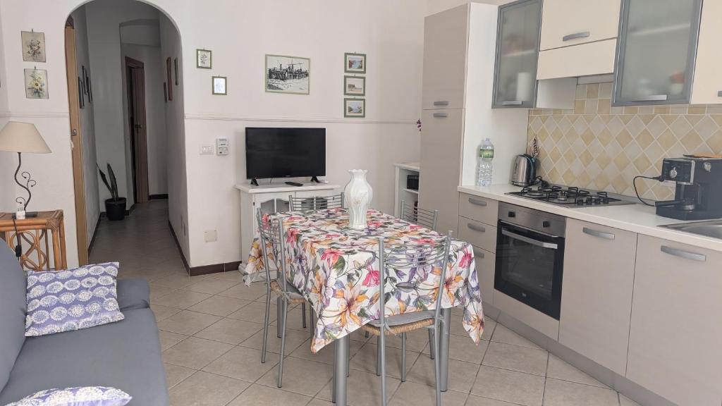 a kitchen with a table with a table cloth on it at Casa Danero "U dabassu" - Centro storico di Carloforte in Carloforte