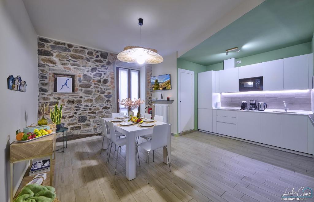 a kitchen and dining room with a table and chairs at Daniel House - Lake and ferry terminal 1 minute walk, in the heart of Bellano in Bellano