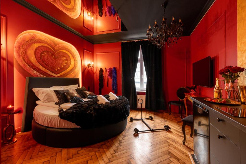 a bedroom with red walls and a bed in a room at Love Krak-Off - BDSM Old Town in Krakow