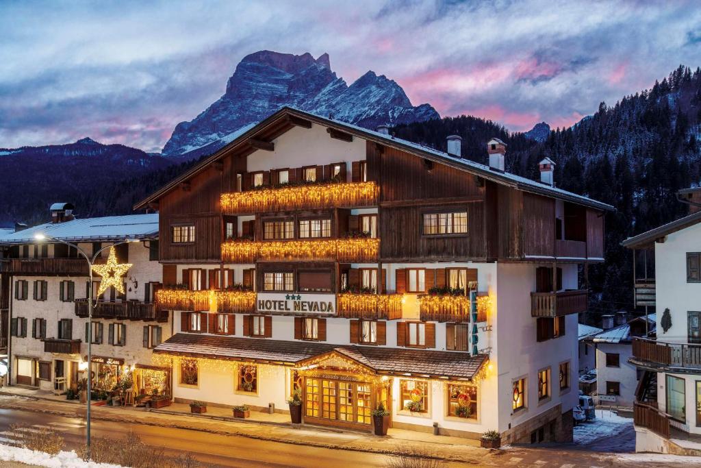 a hotel with a mountain in the background at Best Western Hotel Nevada in San Vito di Cadore