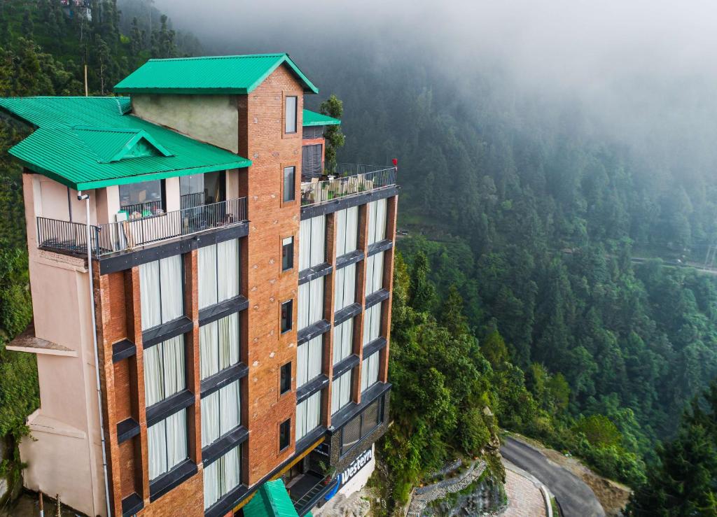 a building with a green roof on top of a mountain at Best Western Dalhousie in Dalhousie