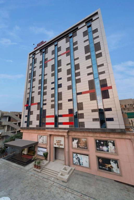 a tall building with red white and blue windows at Best Western Alkapuri, Vadodara in Vadodara