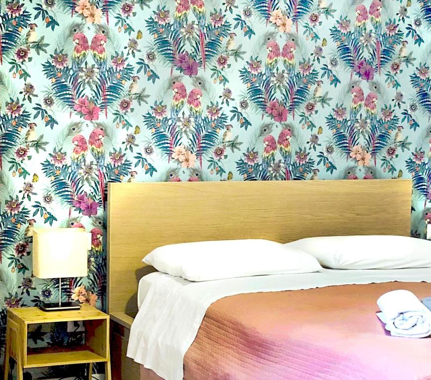 a bedroom with a bed with a floral wallpaper at Sunny Beach Bari in Bari