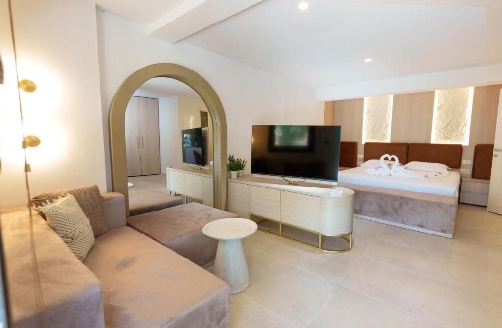 a large living room with a couch and a tv at Filakas in Syvota