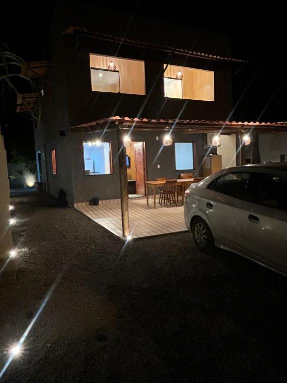 a car parked in front of a house at night at Refúgio do Mar in Ilhéus