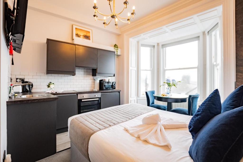 a hotel room with a bed and a kitchen at Superb Marina Hideaway- With kitchen and Wi-Fi in Dublin