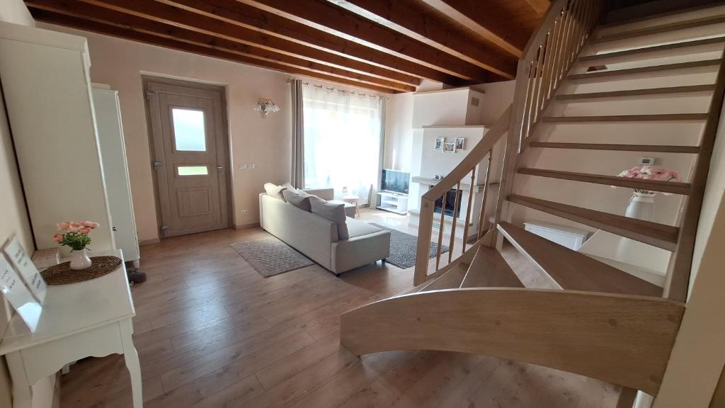 a living room with a staircase and a couch at Villa Elisa in Saluzzo