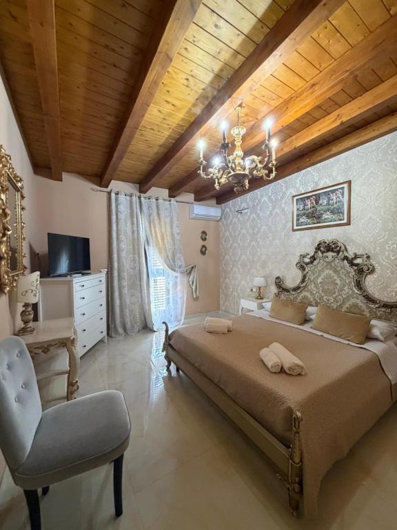 a bedroom with a large bed and a chair at B&B temptation in CTA
