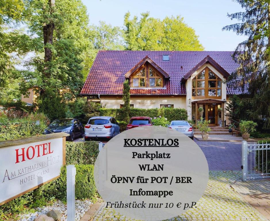 a hotel sign in front of a house at Hotel am Katharinenholz in Potsdam