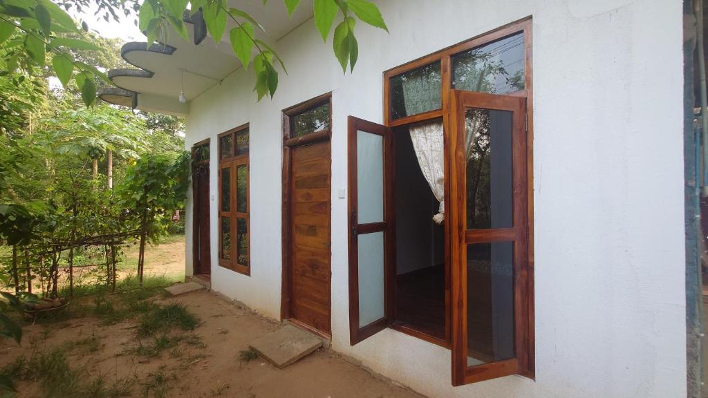 a house with wooden doors on the side of it at ELEPHANT Orphanage View in Udawalawe