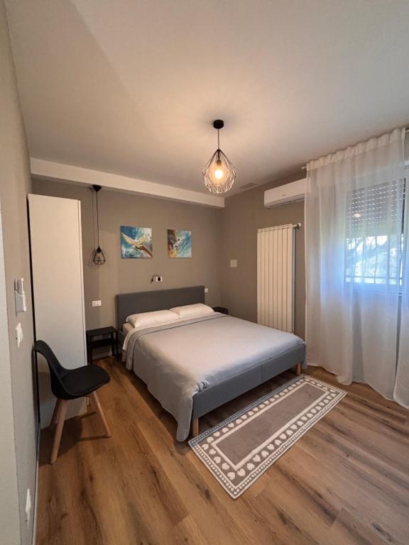 a bedroom with a bed and a chair in it at Colibrì Art B&B in San Martino in Argine