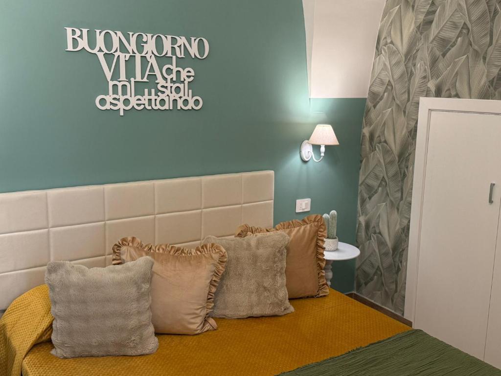 a bedroom with a bed with pillows on it at Pepe 25 in Ruvo di Puglia