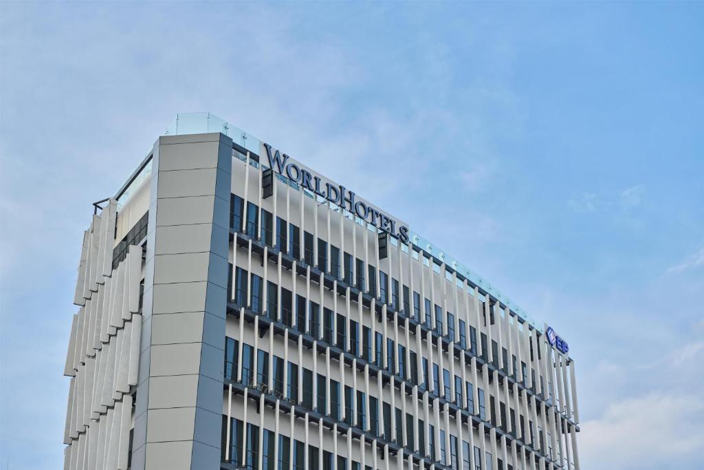 a building with a sign on the top of it at WorldHotels Guadalajara Zona Andares in Guadalajara