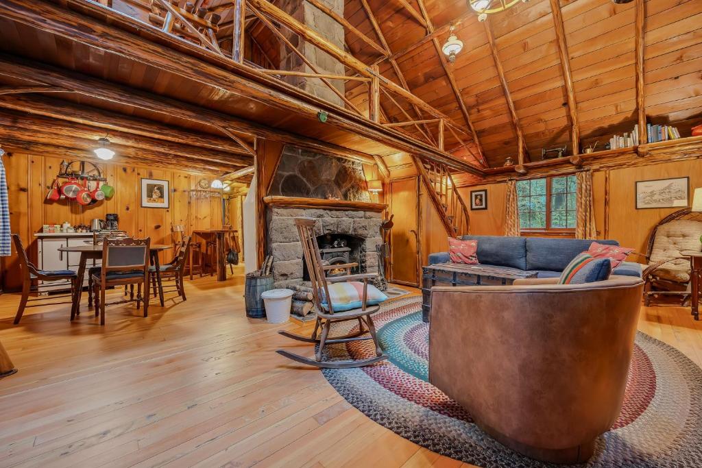 a living room with a couch and a fireplace at Mountain Air Cabin in Welches