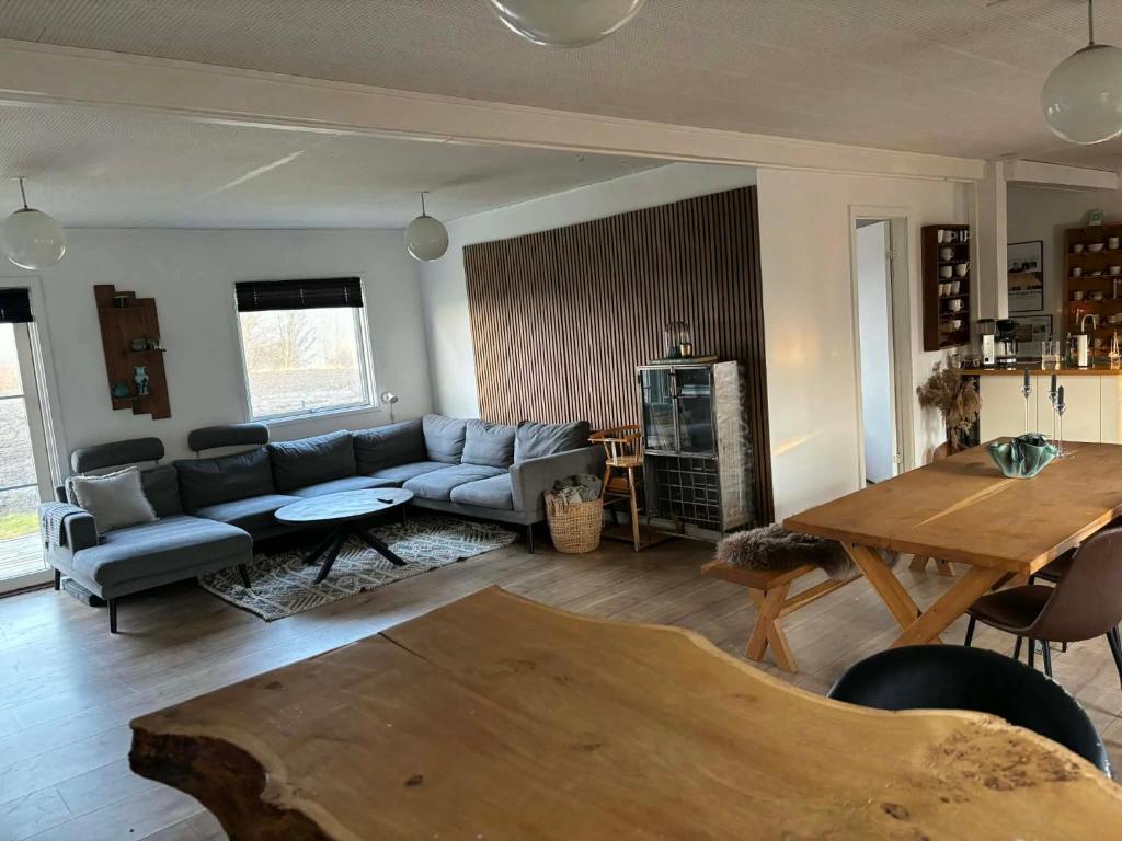 a living room with a couch and a table at Oasen in Nørresundby