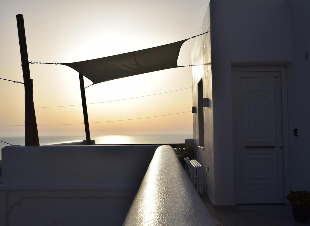 a view of the sunset from the balcony of a house at Enalios House in Vourvoúlos