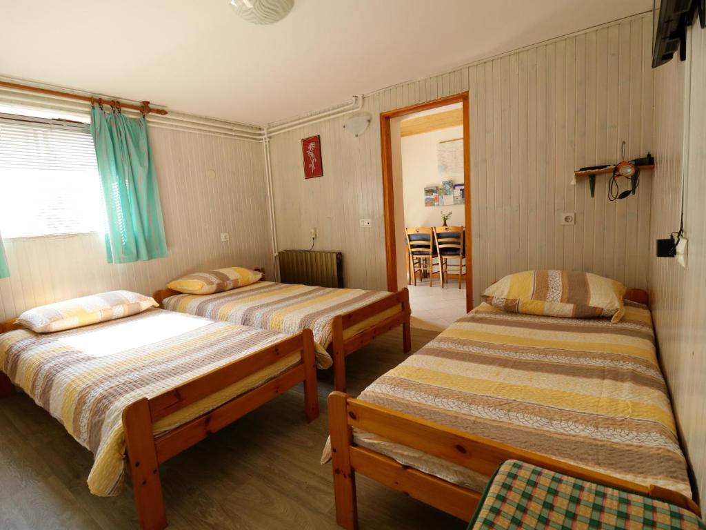 a bedroom with two beds and a window and a room at Apartma Rutar in Tolmin
