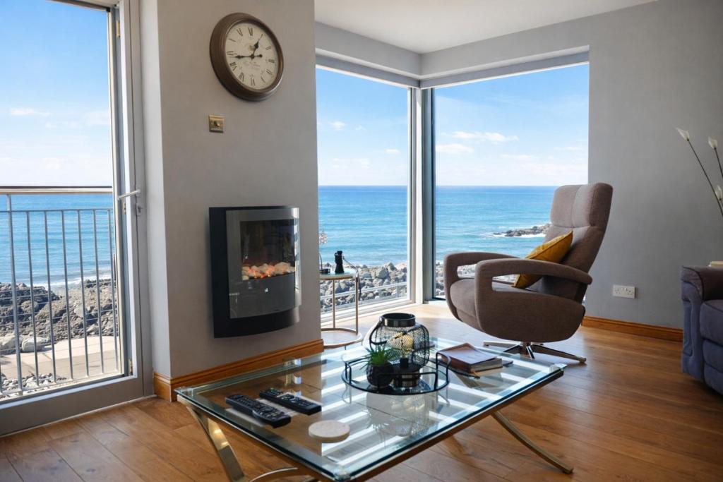 a living room with a view of the ocean at Portstewart promenade apartment with sea views in Portstewart