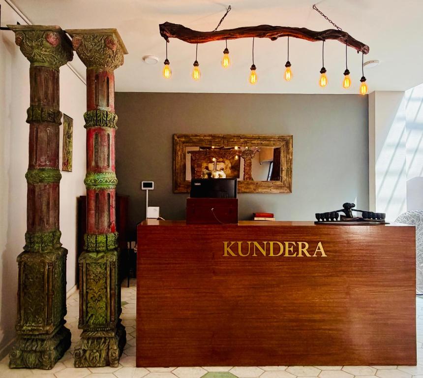 a lobby with two columns and a reception desk at Kundera Hotel Boutique in Colima