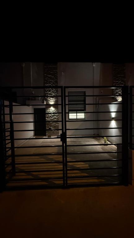 a view through a gate of a building at night at Loft Horizonte Viedma in Viedma