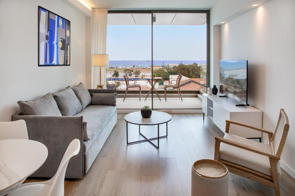 a living room with a couch and a table at L Residences & Suites in Larnaca