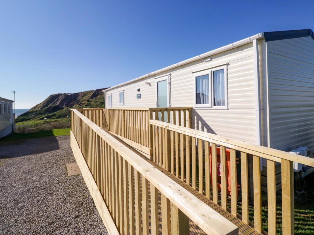a wooden ramp leading up to a tiny house at Guillemot in St Bees