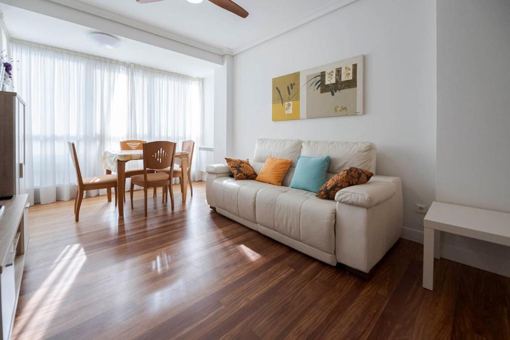 a living room with a couch and a table at Bañeru Zarautz Centro - Sol, playa y confort, todo a un paso in Zarautz