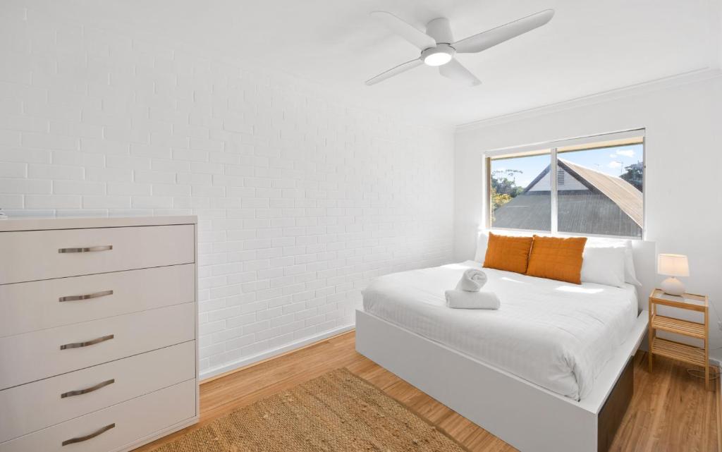 a white bedroom with a bed and a window at Georgies Simple Base in Mosman Park in Mosman Park