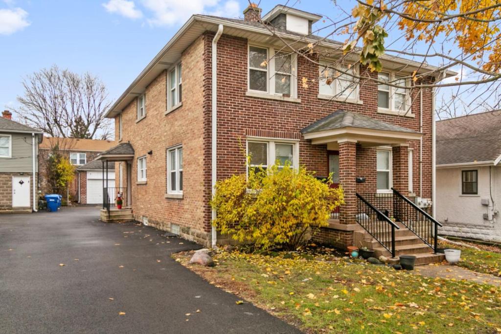 a brick house with a driveway in front of it at USS Alexandria in Highwood