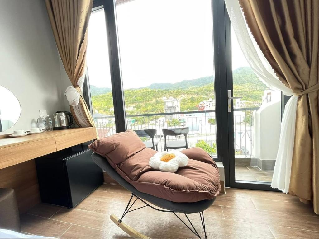 a room with a chair with a stuffed animal on it at ArionHotel in Ninh Hải