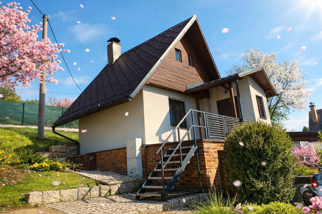 a house with a metal roof and a staircase at Chaloupka Jeřmanice in Jeřmanice