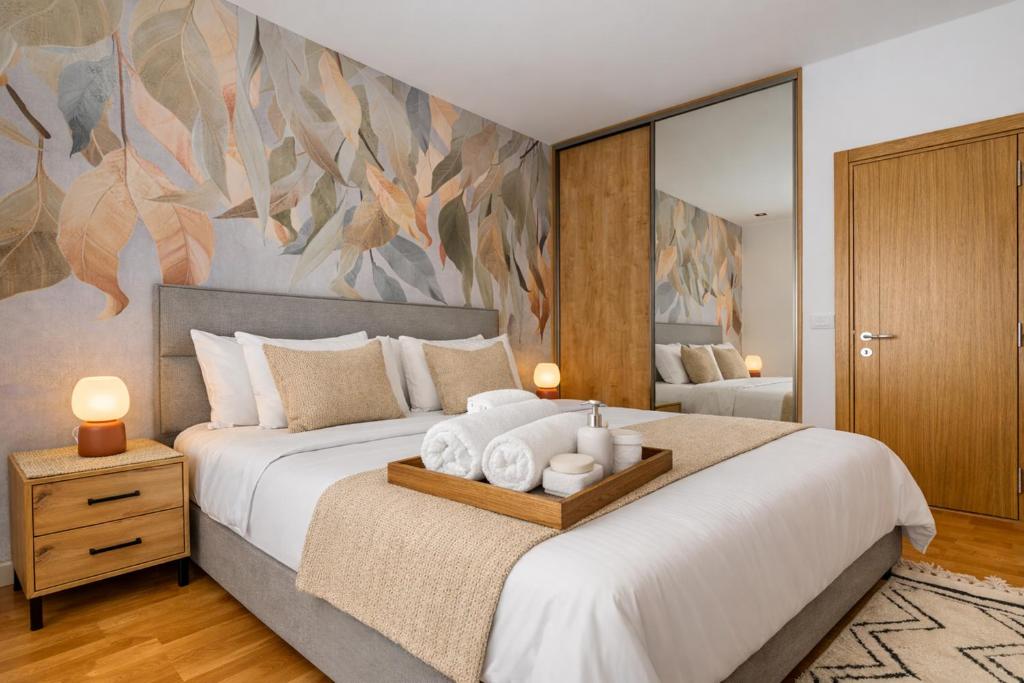 a bedroom with a large bed with towels on it at Boho Dream Apartments in Ulcinj