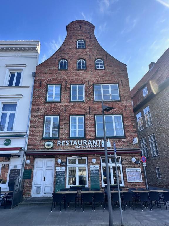 a tall red brick building with a tall tower at Appartementhaus Obertrave in Lübeck